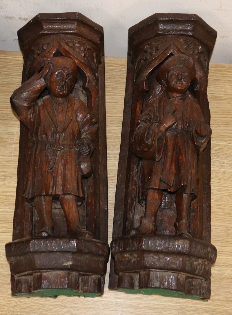 A pair of Italian carved oak figural wall shelves, length 42cm